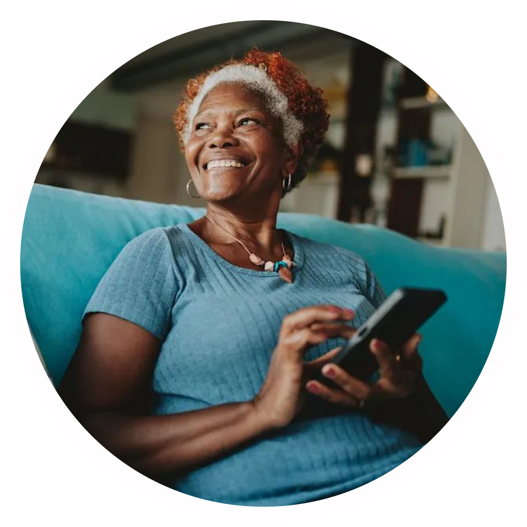 A woman smiling while using her phone