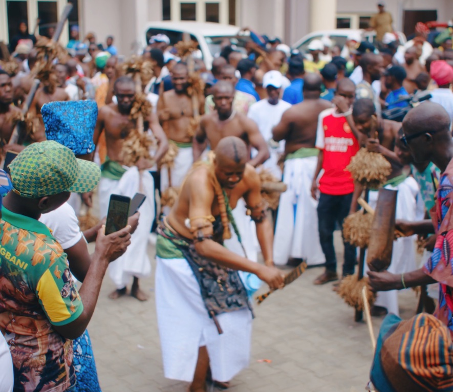 A crowd gathered around a traditional dance performance